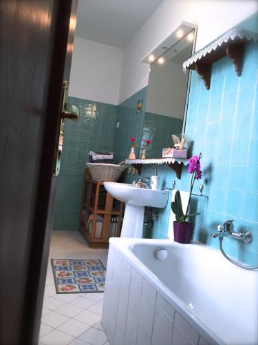 a bathroom with a tub and a sink and a mirror at Maison Diamanti in Castel di Lama