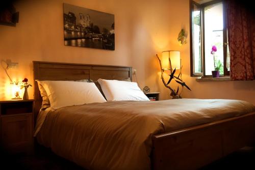 a bedroom with a large bed with two pillows at Maison Diamanti in Castel di Lama