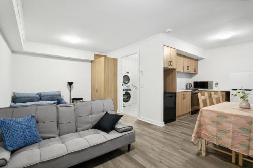 a living room with a couch and a kitchen at Cozy Stays - Private Rooms in Adelaide CBD with Shared Facilities in Adelaide