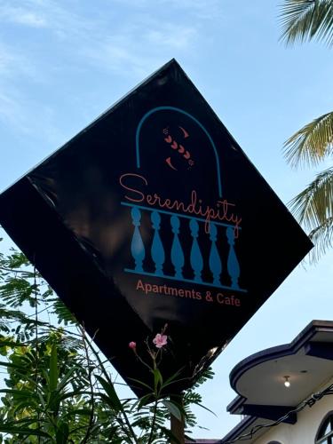 a sign for the aquariumants and cafe at Serendipity Goa - Apartments and Cafe in Arambol