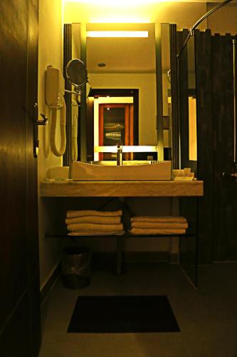 a bathroom with a sink and a mirror at Lahore Continental Hotel in Lahore