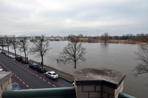 a flooded street with cars parked next to a river at Boetiek Hotel Kampen in Kampen