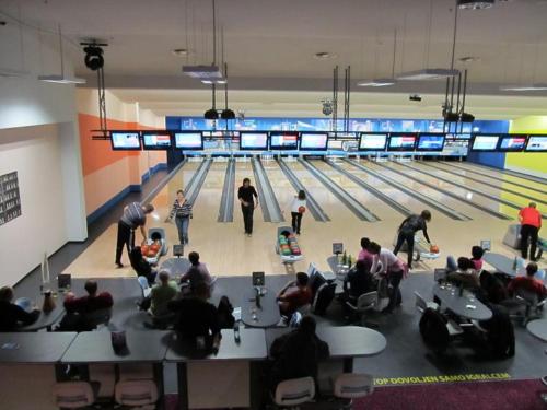 a group of people sitting in front of a bowling alley at Apartma Trobentica 15 in Moravske Toplice