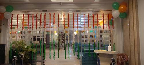 a room with a glass door with flags and balloons at Geetanjali International in Deoghar