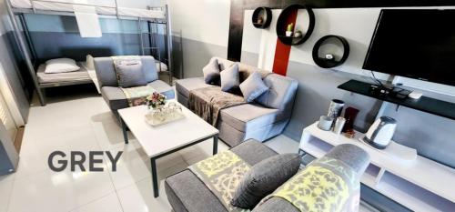 a living room with a couch and a table at ROCCA Del GARDA Residences in Binangonan