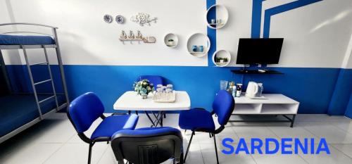 a blue and white room with a table and chairs at ROCCA Del GARDA Residences in Binangonan
