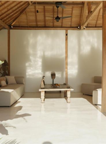 a living room with a table and a couch at Villa Maja Bingin Boutique Hotel in Uluwatu