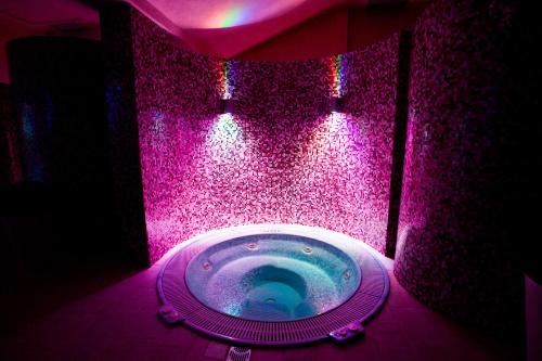 a purple bathroom with a toilet with a purple wall at Palace Hotel San Michele in Monte SantʼAngelo