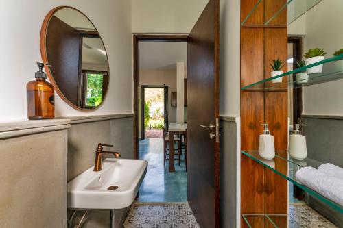 a bathroom with a sink and a mirror at La Olalian 2 & 3 BHK Designer Villas Near Anjuna Beach with Private Pool & Sun Deck & Garden in Anjuna