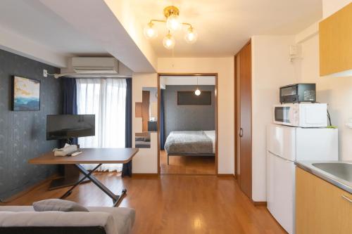 a small apartment with a kitchen and a bedroom at Impulse Imazato in Osaka