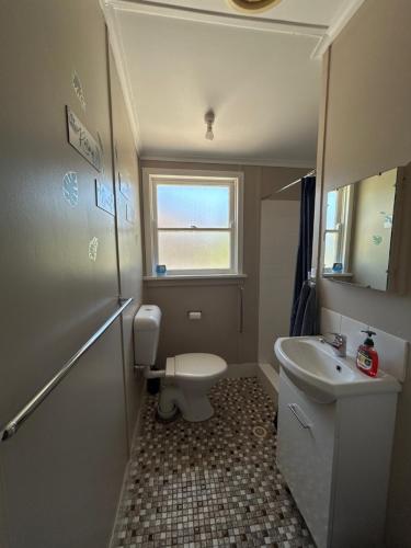 a small bathroom with a toilet and a sink at #2 Waddell Studio Apartment in Canowindra