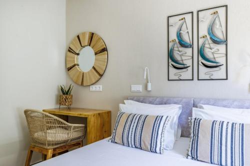a bedroom with a bed and a clock on the wall at Limnonari Double room in Skopelos Town