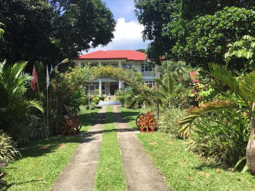 a house in the middle of a garden at Camiguin Lanzones Resort in Mambajao