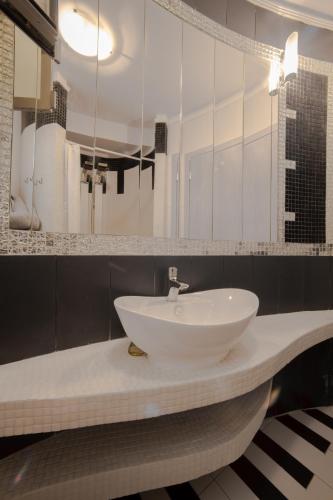 a bathroom with a white sink and a mirror at Oniro Luxury Villas in Toroni