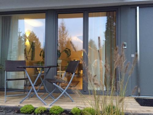 a patio with a table and chairs in front of a building at Ferienapartment am Möhnesee in Möhnesee