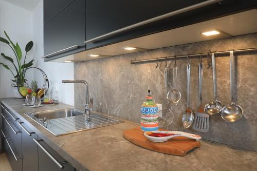 a kitchen with a sink and a counter with utensils at Ferienhaus Viktoria in Abfaltersbach