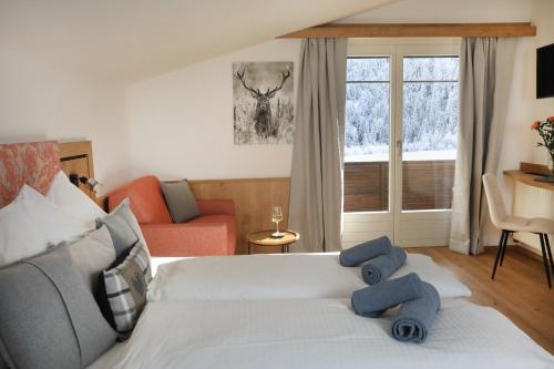 a bedroom with a bed with blue towels on it at Ferienhaus Viktoria in Abfaltersbach