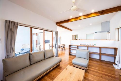 a living room with a couch and a table at Casa Villa 連歌屋 Wooden detached house in Dazaifu in Dazaifu