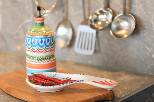 a colorful vase sitting on a table with a plate of food at Ferienhaus Viktoria in Abfaltersbach