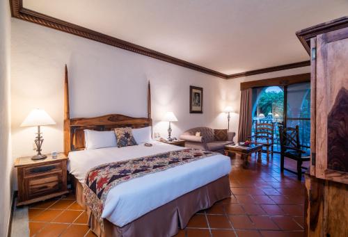 a bedroom with a large bed and a living room at Promisedland Resort & Lagoon in Shoufeng