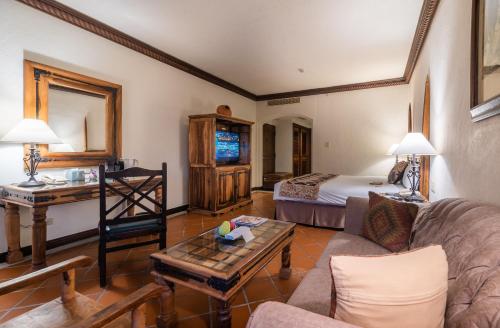 a living room with a bed and a couch at Promisedland Resort & Lagoon in Shoufeng