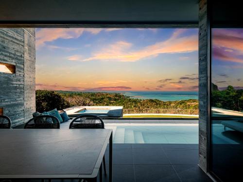 a house with a view of a swimming pool at Iluvio Resort Motobu in Motobu