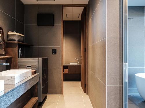 a bathroom with a toilet and a sink at Iluvio Resort Motobu in Motobu