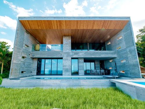 a modern house with a swimming pool at Iluvio Resort Motobu in Motobu