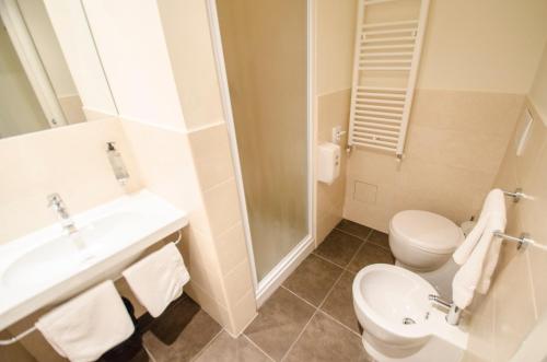a bathroom with a toilet and a sink and a shower at Hotel Iris in Perugia
