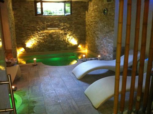 a bathroom with a green tub in a stone building at Aurelia Garden Gold B&B in Rome