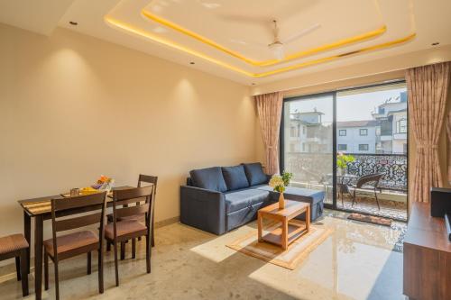 a living room with a couch and a table at ELIVAAS Kamerios Maris 1BHK Apartment with Jacuzzi in Goa