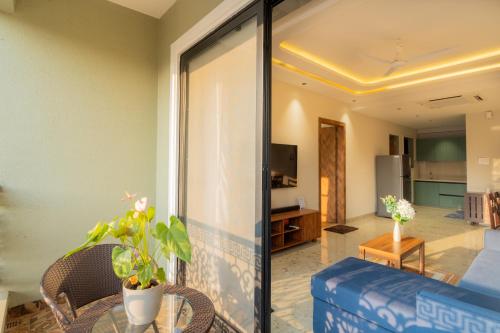 a living room with a couch and a table at ELIVAAS Kamerios Maris 1BHK Apartment with Jacuzzi in Goa