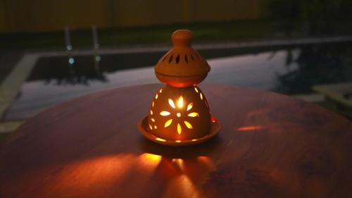 a small lamp sitting on top of a table at OMA Hikkaduwa in Hikkaduwa