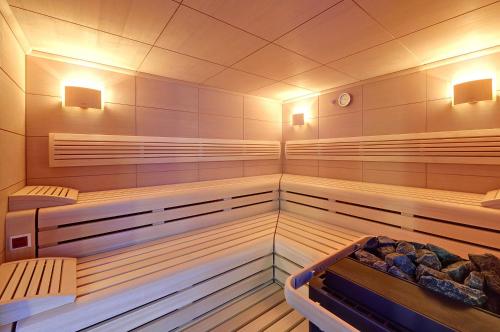 a sauna with two benches and a tub in it at Schloss Kartzow in Potsdam
