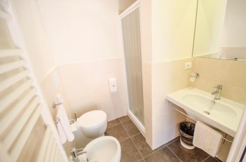 a bathroom with a toilet and a sink at Hotel Iris in Perugia