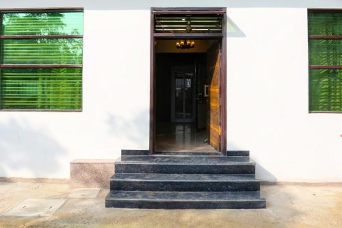 a stairway leading to a door in a building at Hotel O Rajhans in Gurgaon