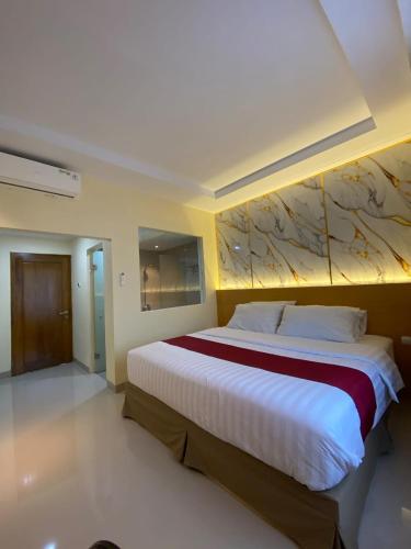 a bedroom with a large bed in a room at Wisma HN in Selang