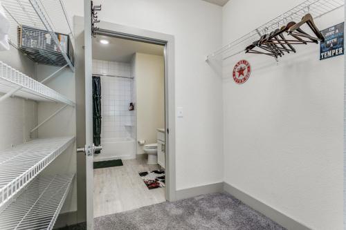 a walk in closet with a toilet and a clock on the wall at San Antonio TX Condo on Riverwalk w King Ste,Pets in San Antonio