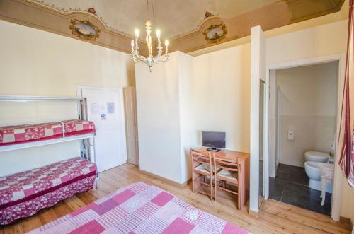 a bedroom with a bunk bed and a desk at Hotel Iris in Perugia