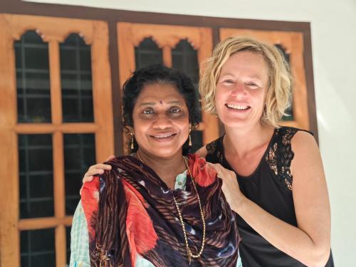 two women standing in front of a building at Kailasam Home Stay in Munroe Island