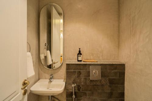 a bathroom with a sink and a mirror at ELIVAAS Solace Azure 4 BHK Villa with Pvt Pool in Calangute