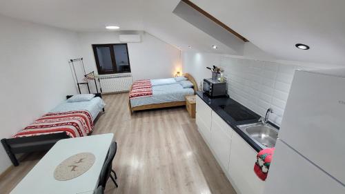 a small room with two beds and a sink at Private Room - Terasa - Gradina in Paşcani