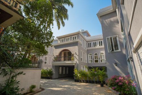 an image of a house with a courtyard at ELIVAAS Solace Azure 4 BHK Villa with Pvt Pool in Calangute