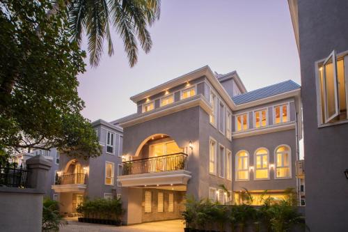 a large house with lights on at ELIVAAS Solace Azure 4 BHK Villa with Pvt Pool in Calangute