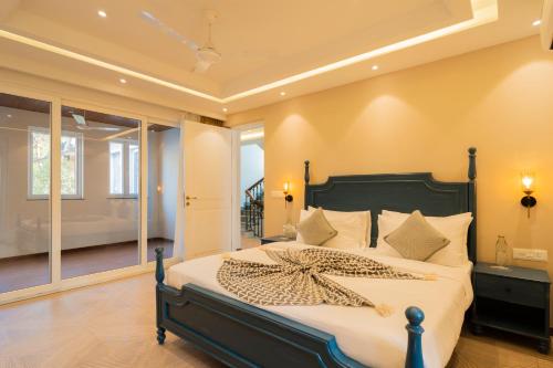 a bedroom with a bed with a starfish on it at ELIVAAS Solace Azure 4 BHK Villa with Pvt Pool in Calangute