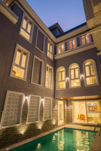 a house with a swimming pool in front of it at ELIVAAS Solace Azure 4 BHK Villa with Pvt Pool in Calangute
