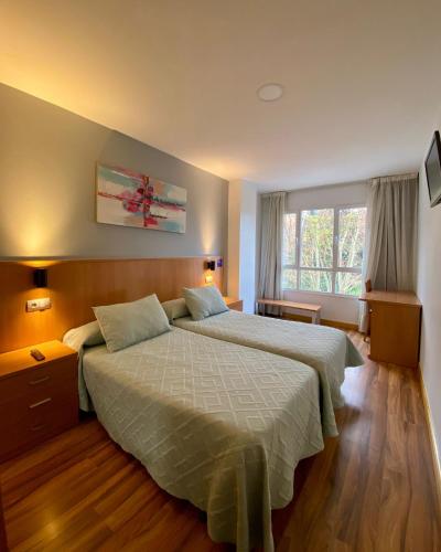 Ένα ή περισσότερα κρεβάτια σε δωμάτιο στο Hostal RIO SELMO