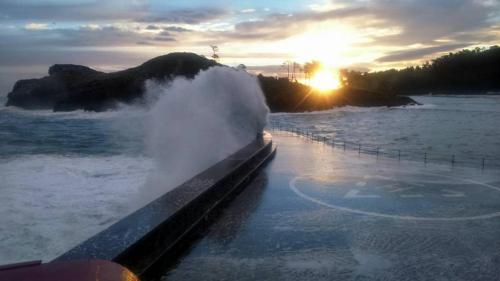 a wave in the water at the edge of the ocean at Lekeitio Aterpetxea Hostel in Lekeitio