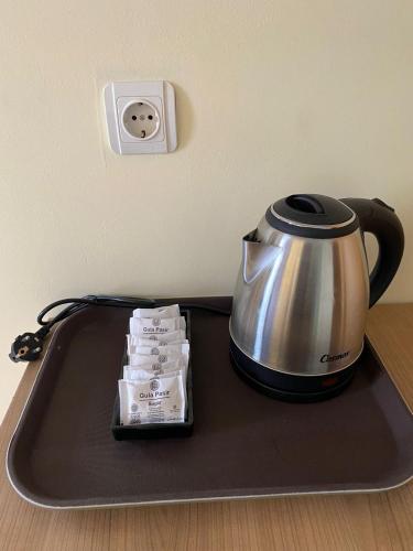 a tea kettle on a tray on a table at Wisma HN in Selang
