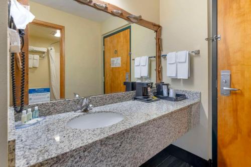 a bathroom counter with a sink and a mirror at Quality Inn Ashland - Lake Superior in Ashland